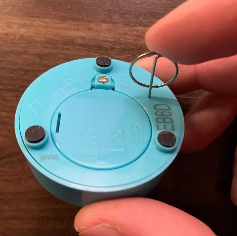 The bottom of a Connect Button, with the linking pin inserted in the small link hole.
